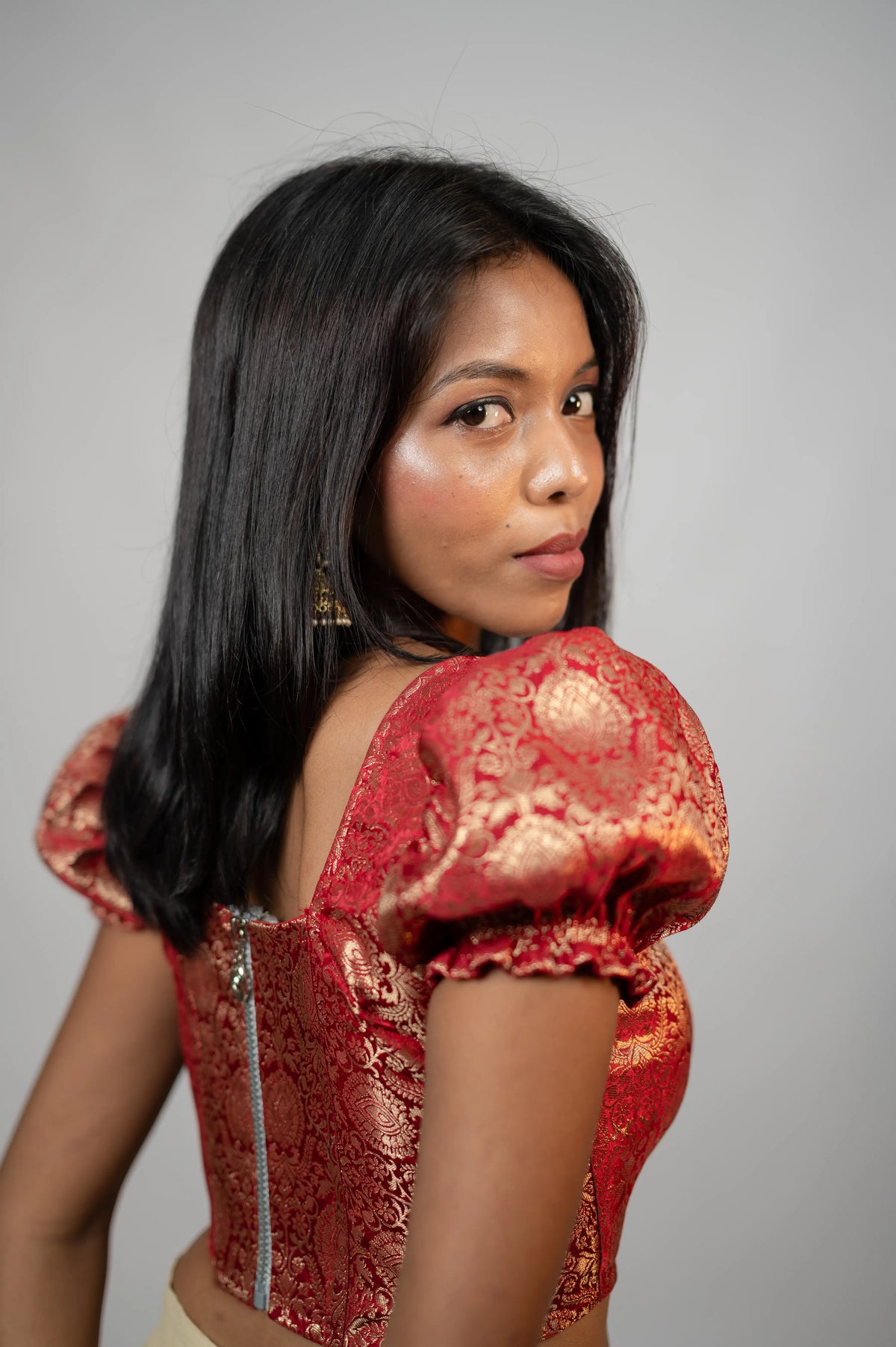 Back view of Crimson Noor crimson brocade puff sleeve corset with zipper closure